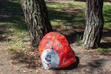 Large stone ladybird. Landscape design in the park. Use of natural materials in design.