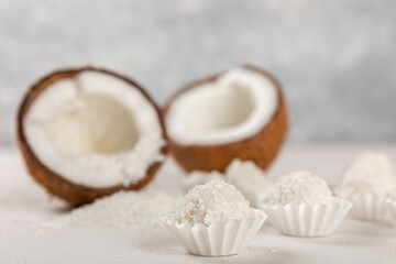 Coconut candies on a wooden background. Candies with chocolate, almonds and delicate butter cream. Coconut flakes. tasty sweets.Tasty ball-shaped chocolate candies.Dessert. Space for text.copy space