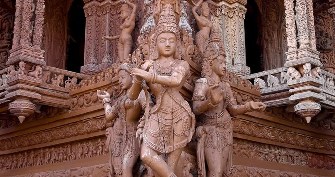Intricate exterior wooden architecture of Hindu gods on Sanctuary of Truth temple in Pattaya city, Thailand