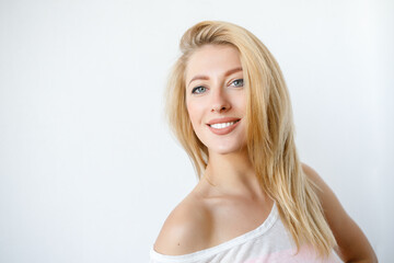 Pretty smiling joyfully female looking with satisfaction at camera