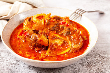 ossobuco, stewed meat knuckle on the bone, with oats and spices, homemade, no people,