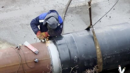 Welder shall cut the weld using an angle grinder on a large diameter pipe prior to welding