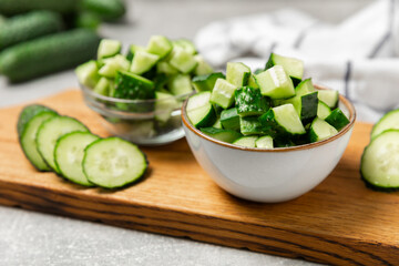 Cucumber on wooden background. Slice of cucumber on background. Fresh organic green cucumbers gherkin. Vegan. Salad ingredient. Farm vegetables. Cut vegetables with knife. Space for text. Copy space