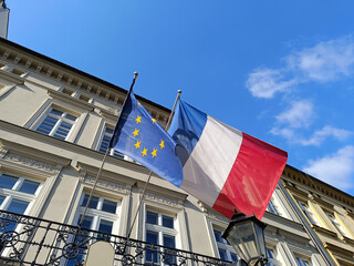 European Union and French Flags Waving on Historical Building under Blue Sky