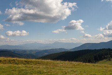 Summer landscape in mountains and the dark blue sky with clouds