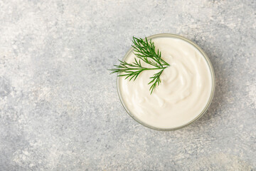 Cucumber sour cream tzatziki sauce on a wooden table.Tartar sauce. Traditional delicious appetizer. yogurt sauce. Tzatziki with ingredients cucumber, garlic,dill,lemon,mint. salad dressing.Copy space