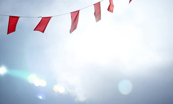 Red pennant garland decoration hanging on a string, perfect for party, carnival, festival, or celebration.