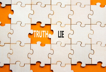 Fototapeta premium Truth or Lie symbol. Concept word Truth or Lie on wooden puzzle. Beautiful orange background. Business and Truth or Lie concept. Copy space