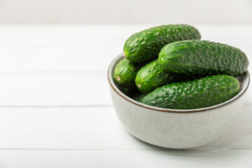 Cucumber on wooden background. Slice of cucumber on background. Fresh organic green cucumbers gherkin. Vegan. Salad ingredient. Farm vegetables. Cut vegetables with knife. Space for text. Copy space