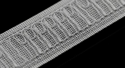 Close-up of intricate white embroidery on fabric textile craft design