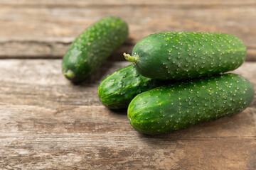 Cucumber on wooden background. Slice of cucumber on background. Fresh organic green cucumbers...