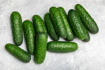 Cucumber on wooden background. Slice of cucumber on background. Fresh organic green cucumbers gherkin. Vegan. Salad ingredient. Farm vegetables. Cut vegetables with knife. Space for text. Copy space