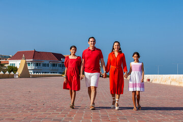Young family of four traveling together. Family love concept. Travel concept. Cartagena de Indias.