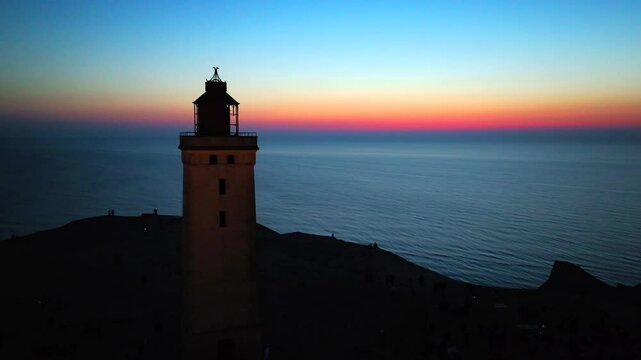 Aerial view of the giant sand dunes with the famous lighthouse on the top of a hill. Rubjerg Knude Lighthouse, , North SeaRubjerg , Sunset at the lighthouse Rubjerg Knude Fyr near Lokken in Denmark. 