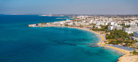 Aerial view of Ayia Napa, Cyprus, showing Nissi Beach, turquoise waters, sandy shores, luxury...