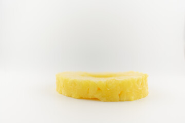 a perfectly cut pineapple ring centered on a pristine white plate, evoking feelings of refreshing sweetness and healthy delight. Ideal for healthy snacks fruit platters, or minimalist food photography