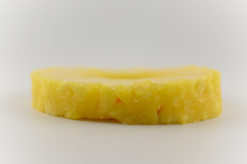 a perfectly cut pineapple ring centered on a pristine white plate, evoking feelings of refreshing sweetness and healthy delight. Ideal for healthy snacks fruit platters, or minimalist food photography