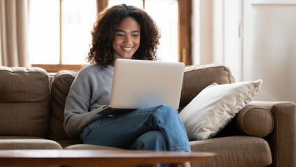Smiling woman working on laptop at home