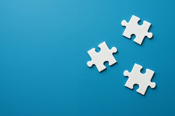 Three white puzzle pieces on blue background with copy space