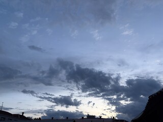 Fototapeta premium Cloudy Evening Sky Over Buildings