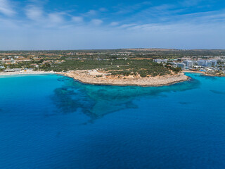 Aerial view of a rocky peninsula in Ayia Napa, Cyprus, surrounded by turquoise waters, sandy...