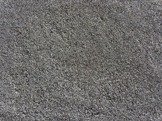 photo of a wall made of small stones held together with concrete