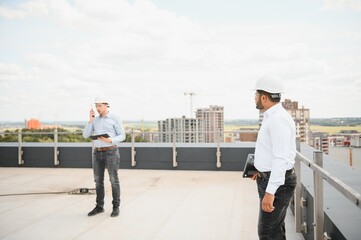 Indian and European construction workers together at a construction site