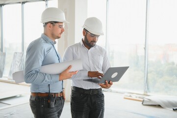 two architect engineers talking in a constructed office building