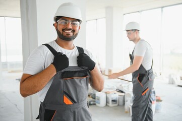 moving, repair and people concept. happy smiling indian worker