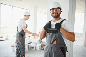Indian worker makes repairs in an apartment