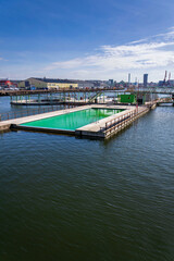 Floating swimming pools with sauna at Allmanna harbour bath in Frihamnen, Gothenburg, Sweden, sunny day
