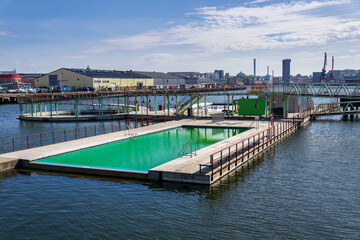 Floating swimming pools with sauna at Allmanna harbour bath in Frihamnen, Gothenburg, Sweden, sunny day