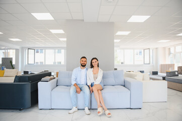 Couple chooses upholstered furniture in store