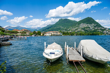 Tourist boat in Lugano lake and Lugano city in canton of Ticino in Switzerland
