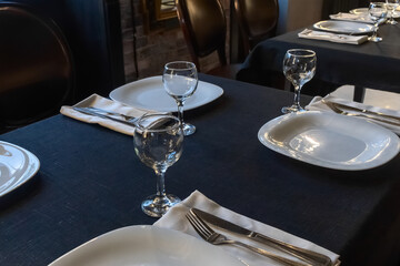 Elegant table setting for a gourmet dinner celebration with fine glassware and stylish cutlery in a modern restaurant ambiance