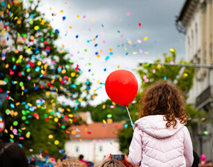 little girl with red balloon at festival