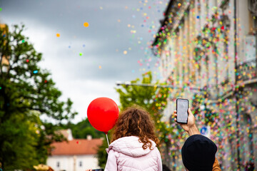 little girl with red balloon at festival