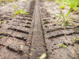 Detailed close-up capturing tire tread patterns on a dusty surface