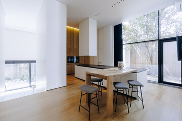 A beautiful kitchen with a black countertop and elegant white cabinets