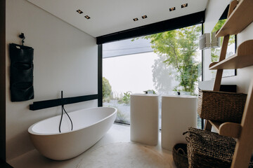 This is a bathroom that contains a tub, a sink, a mirror, and a ladder