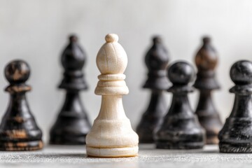 The concept of authenticity and uniqueness is represented by a white pawn standing in a line with selective focus