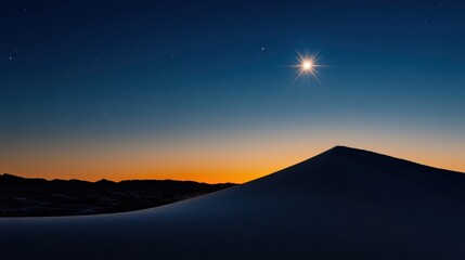 A stunning view captures the tranquility of a sand dune at sunset, as vibrant colors fill the sky. A bright star shines prominently above the horizon, enhancing the beauty.