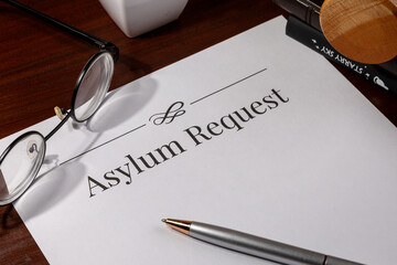 Asylum Request Form on Wooden Desk with Gavel – Immigration and Refugee Law Concept

