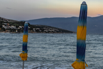 Sunshades on the beach of Baska on the island of KRK, preparation for the tourist season in Croatia
