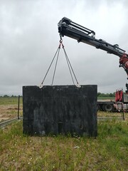 powerful manipulator lifts heavy concrete structure concept. big manipulator. lifting heavy loads