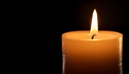 solitary candle burns brightly against dark background casting warm glow that evokes sense of calm and reflection