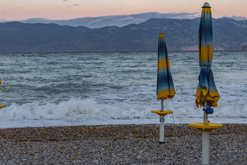 Sunshades on the beach of Baska on the island of KRK, preparation for the tourist season in Croatia