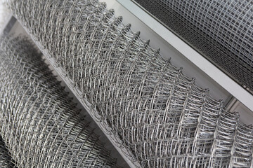 Rolled chain-link fence. Metal mesh netting rolled into rolls