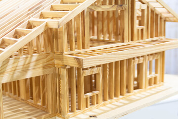 Model of a wooden house frame in an architect's office © DmyTo