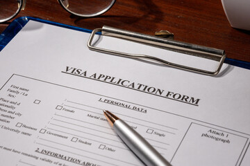 Visa Application Form in Clipboard on Desk – Immigration Document Scene
